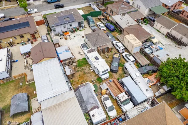 an aerial view of a residential apartment building with parking