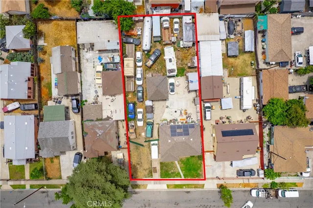 aerial view of residential houses with outdoor space and street view