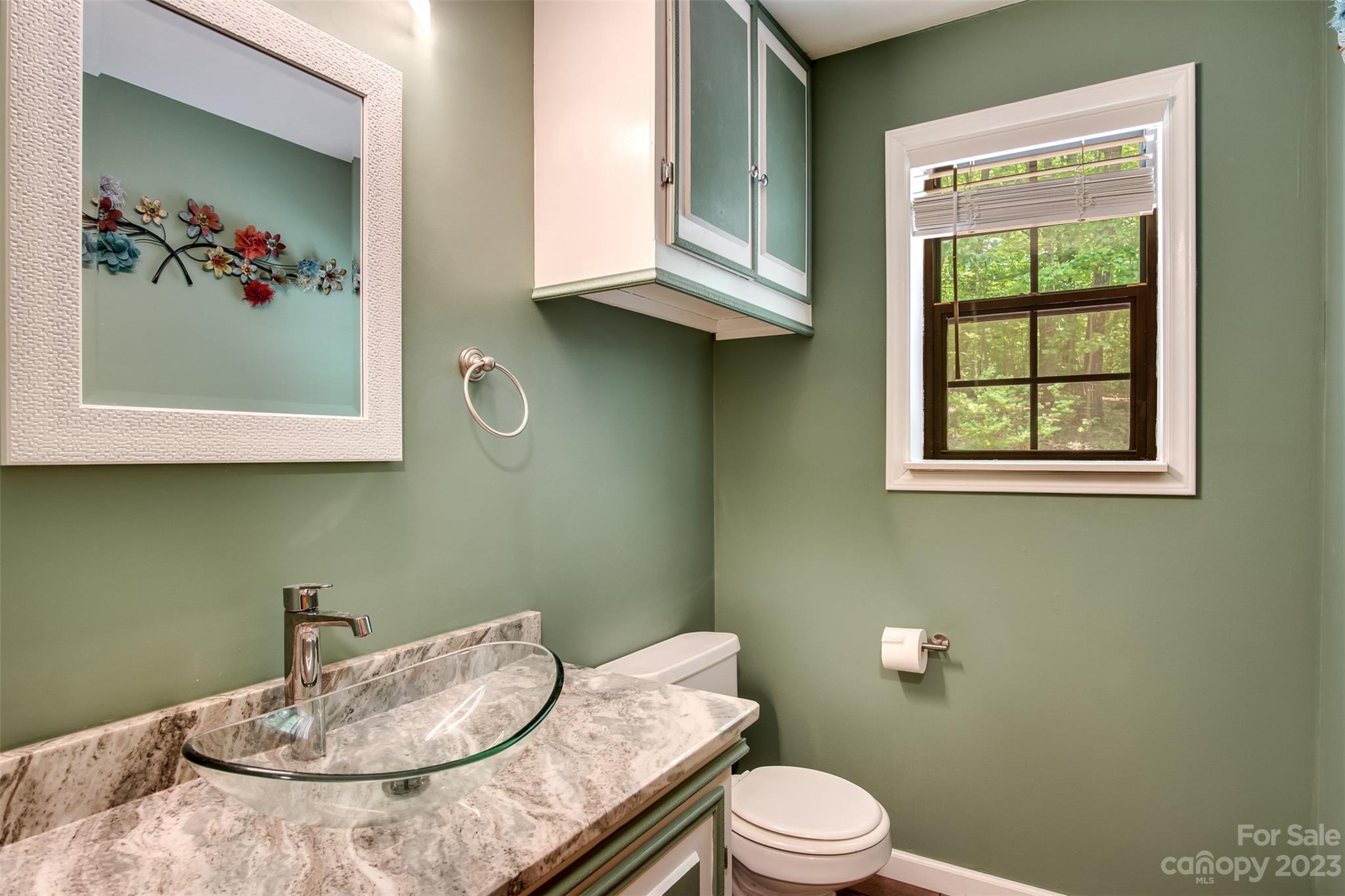 669 Walker Point Road Hayesville, NC 28904 - Photo 14 of 46 a bathroom with a granite countertop sink and a mirror