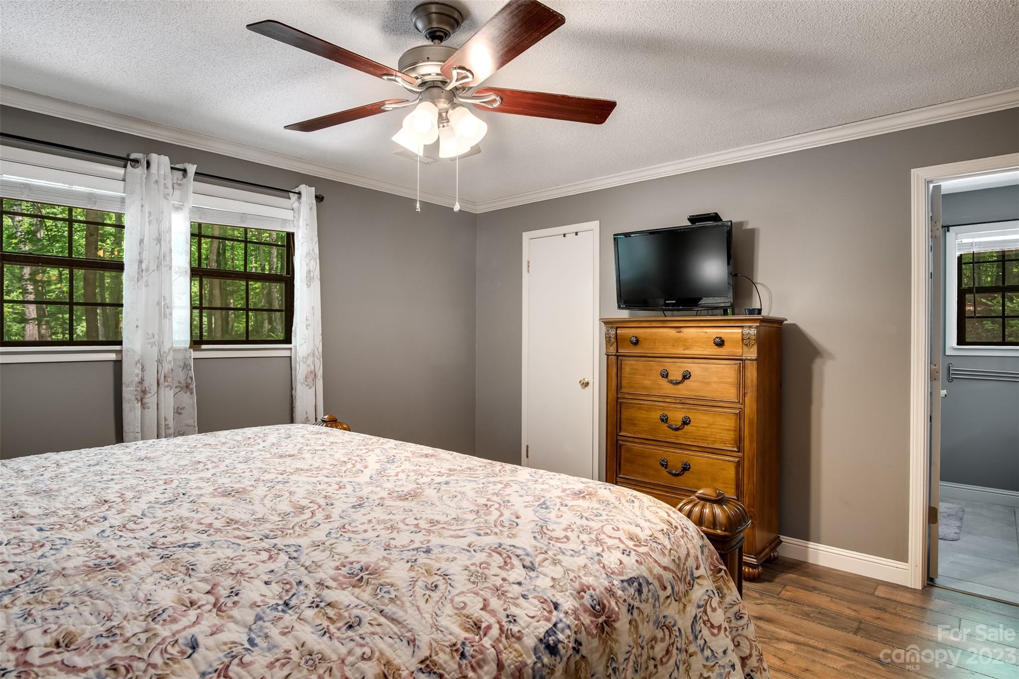 669 Walker Point Road Hayesville, NC 28904 - Photo 16 of 46 a bedroom with a bed and a flat screen tv