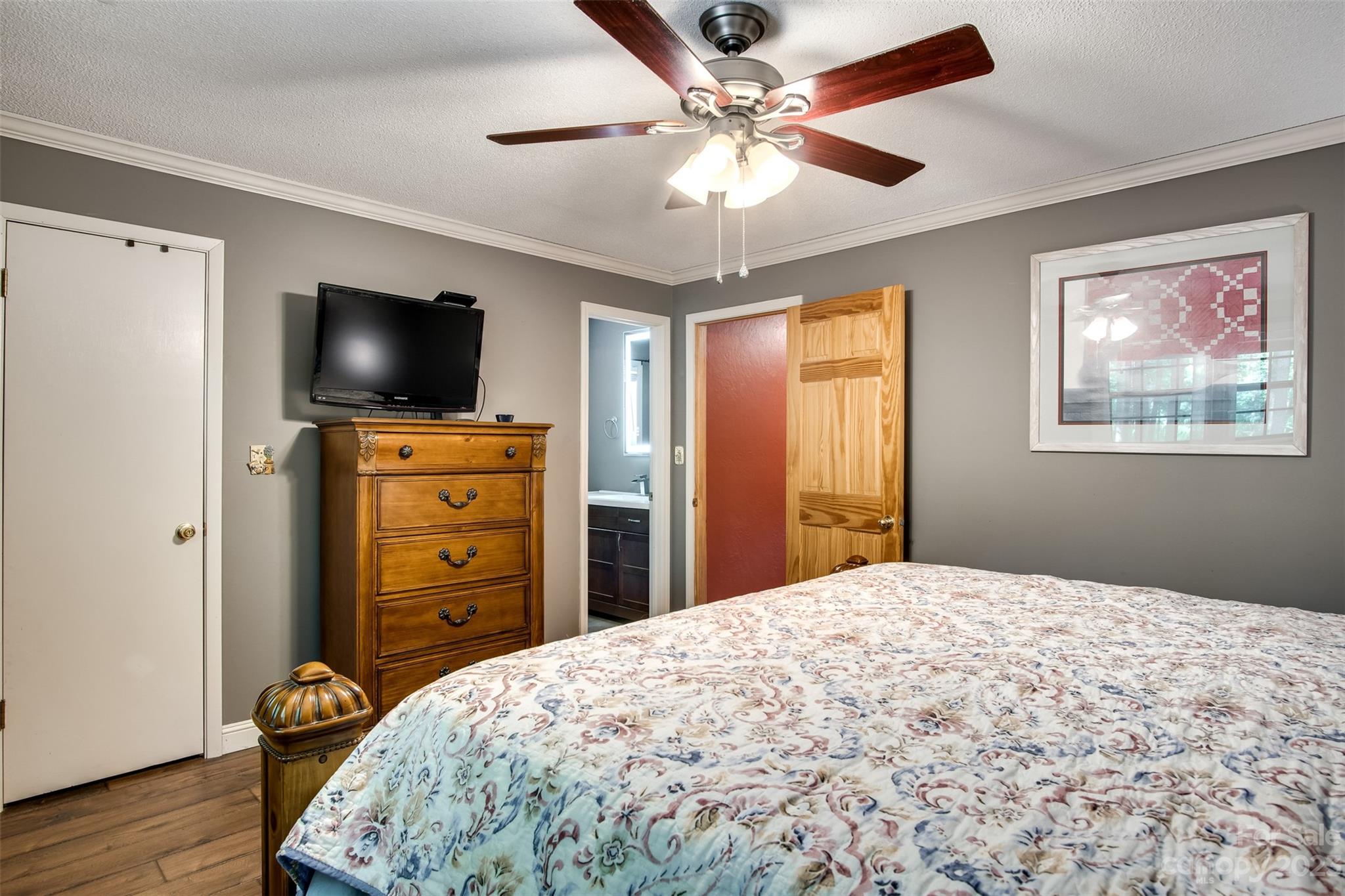 669 Walker Point Road Hayesville, NC 28904 - Photo 17 of 46 a bedroom with a bed and a flat screen tv