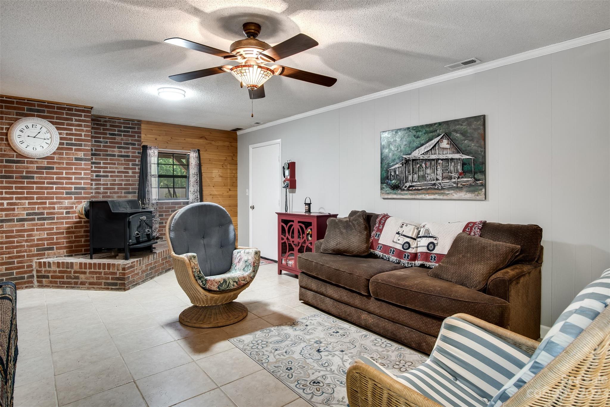 669 Walker Point Road Hayesville, NC 28904 - Photo 22 of 46 a living room with furniture a fireplace and a flat screen tv