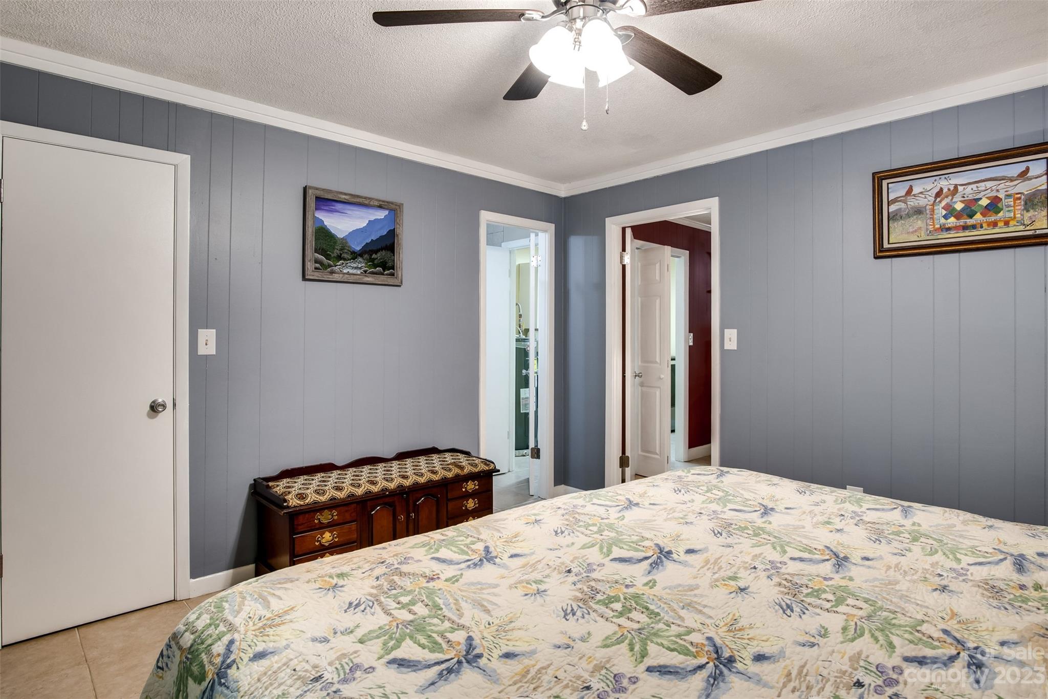 669 Walker Point Road Hayesville, NC 28904 - Photo 24 of 46 a bedroom with a large bed and a chandelier