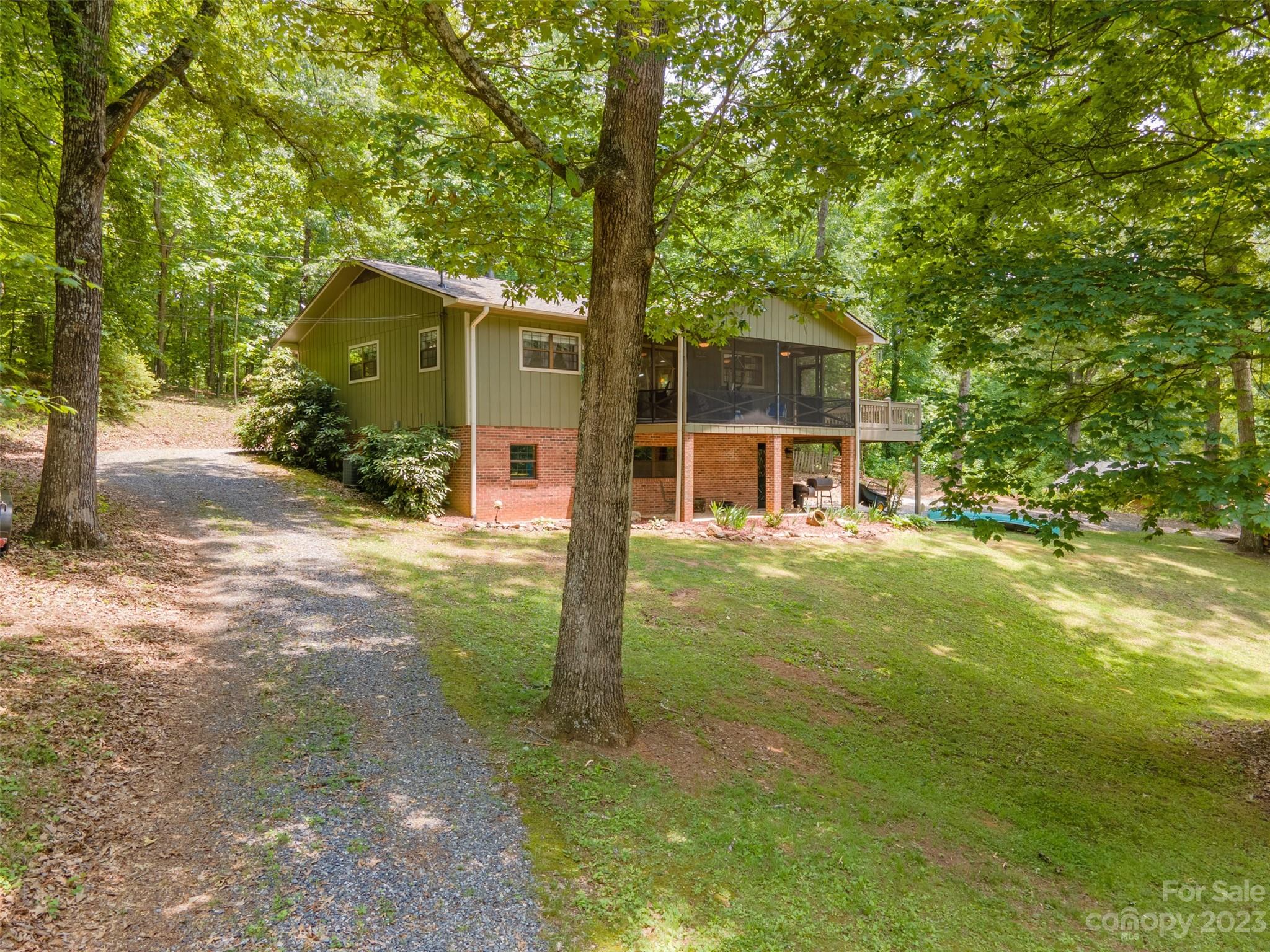669 Walker Point Road Hayesville, NC 28904 - Photo 36 of 46 a view of a house with backyard and a tree