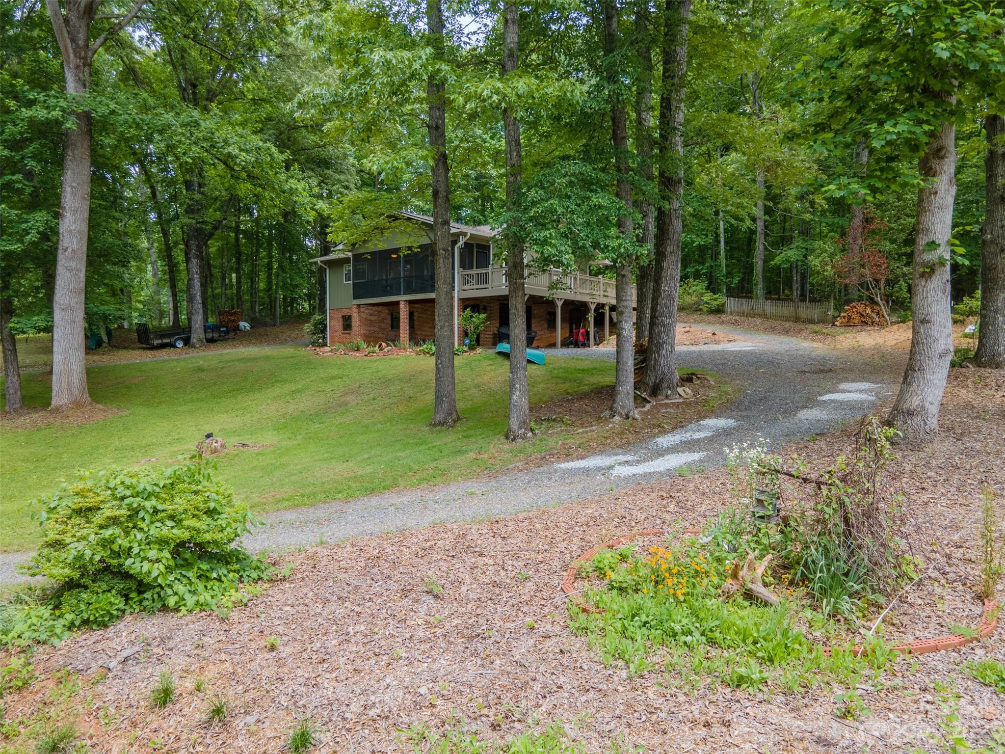 669 Walker Point Road Hayesville, NC 28904 - Photo 37 of 46 a view of a house with backyard and a garden