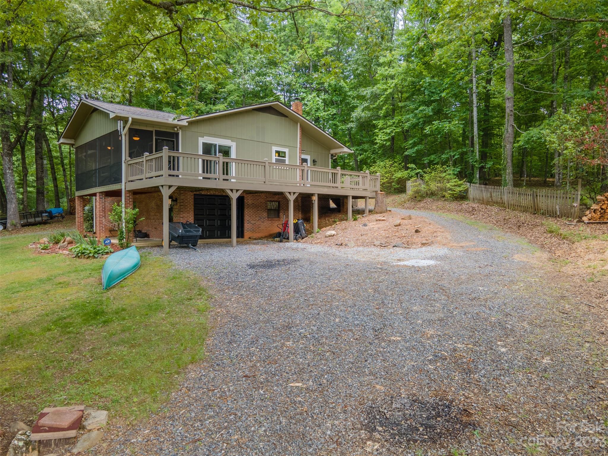 669 Walker Point Road Hayesville, NC 28904 - Photo 39 of 46 a view of a house with a yard and large trees