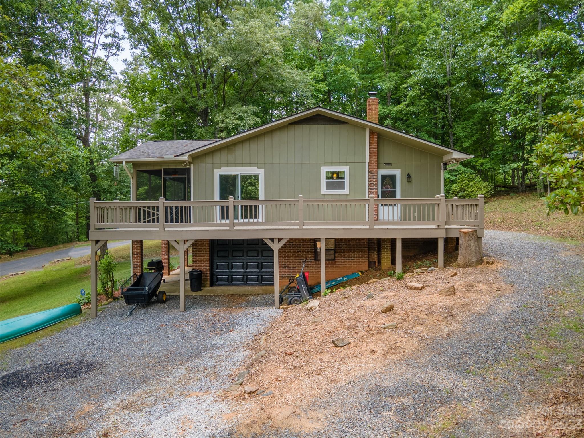 669 Walker Point Road Hayesville, NC 28904 - Photo 40 of 46 a view of a house with a backyard and a patio