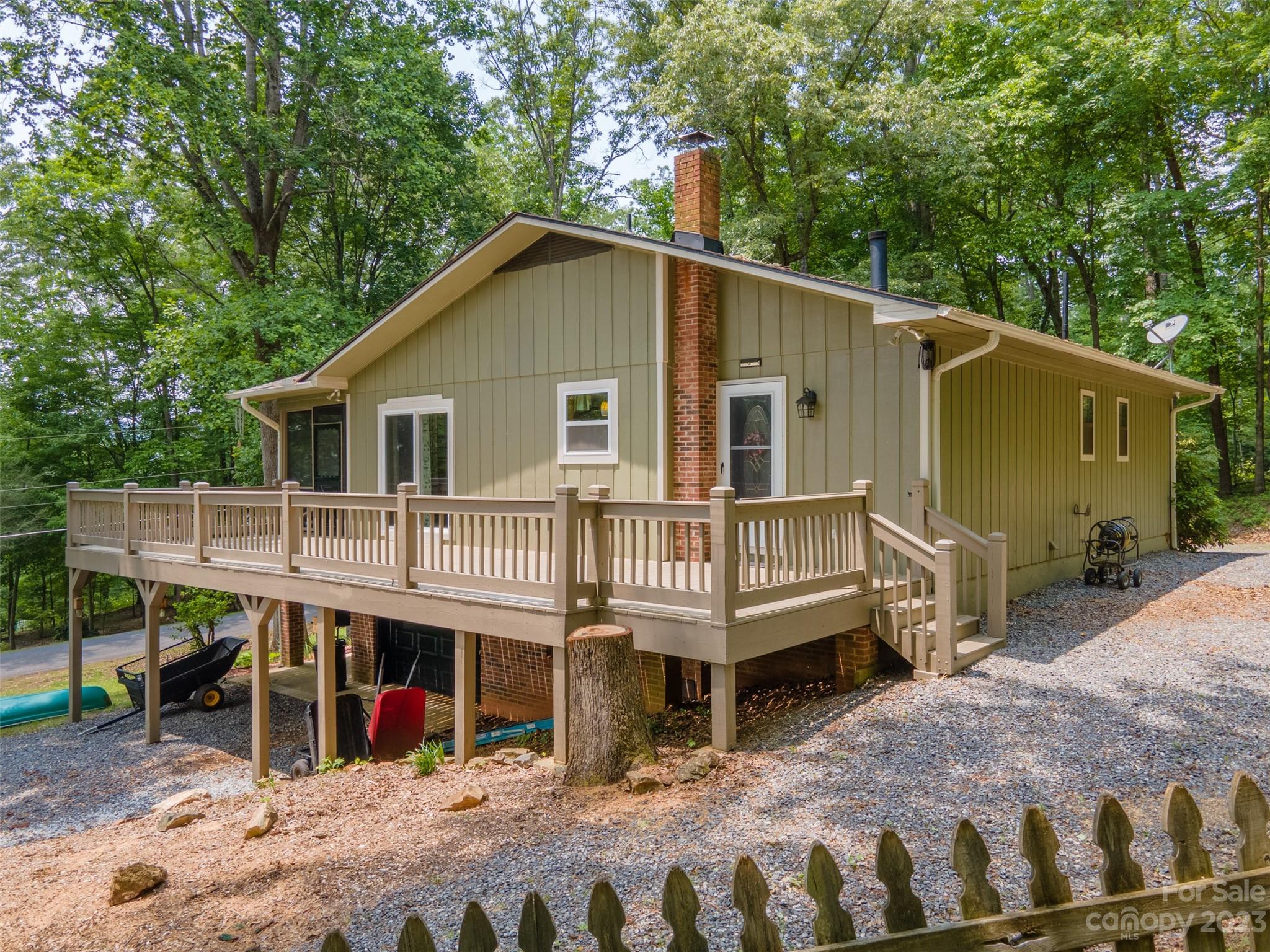 669 Walker Point Road Hayesville, NC 28904 - Photo 41 of 46 a backyard of a house with wooden deck and barbeque oven