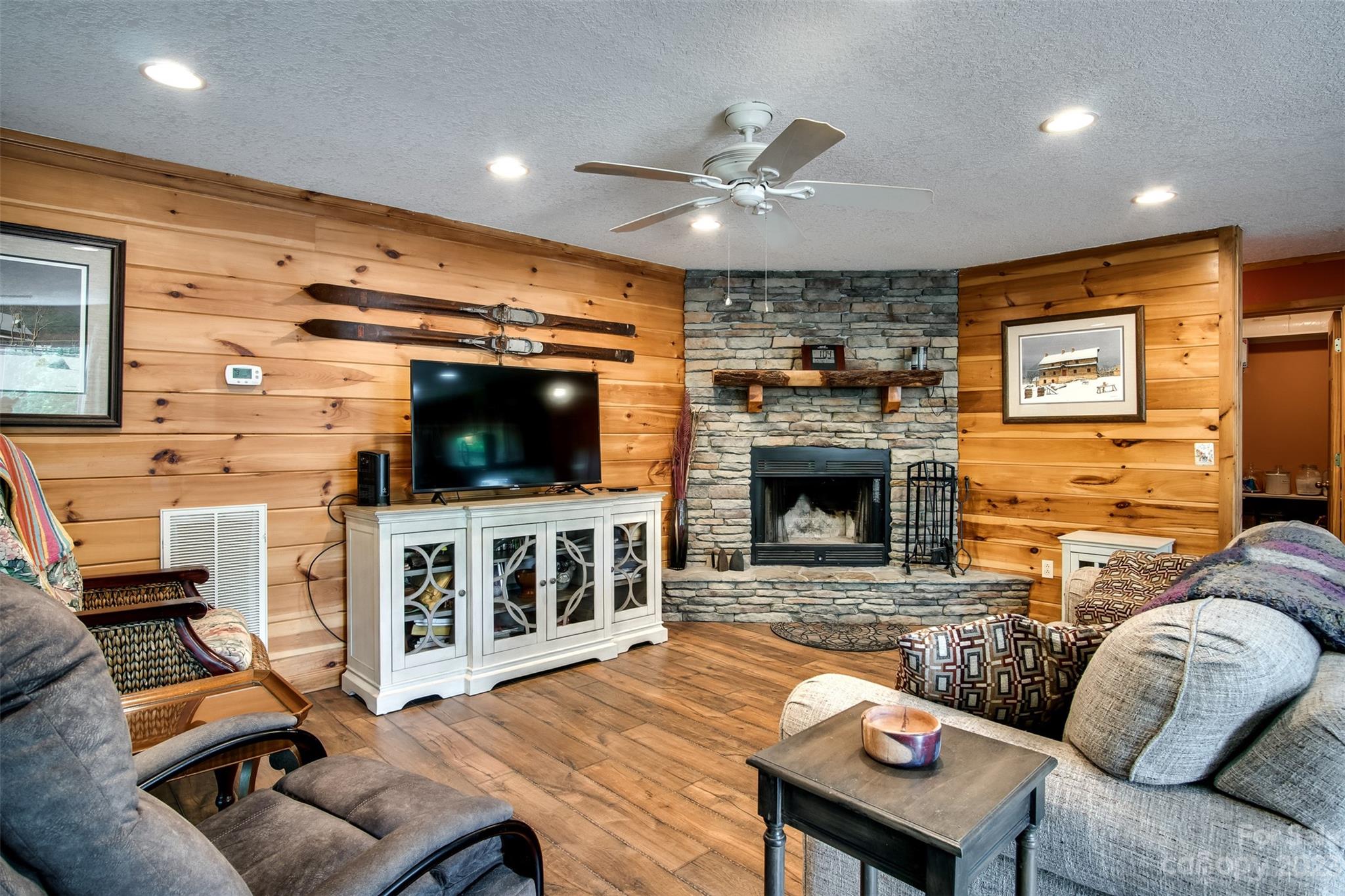 669 Walker Point Road Hayesville, NC 28904 - Photo 7 of 46 a living room with furniture a flat screen tv and a fireplace