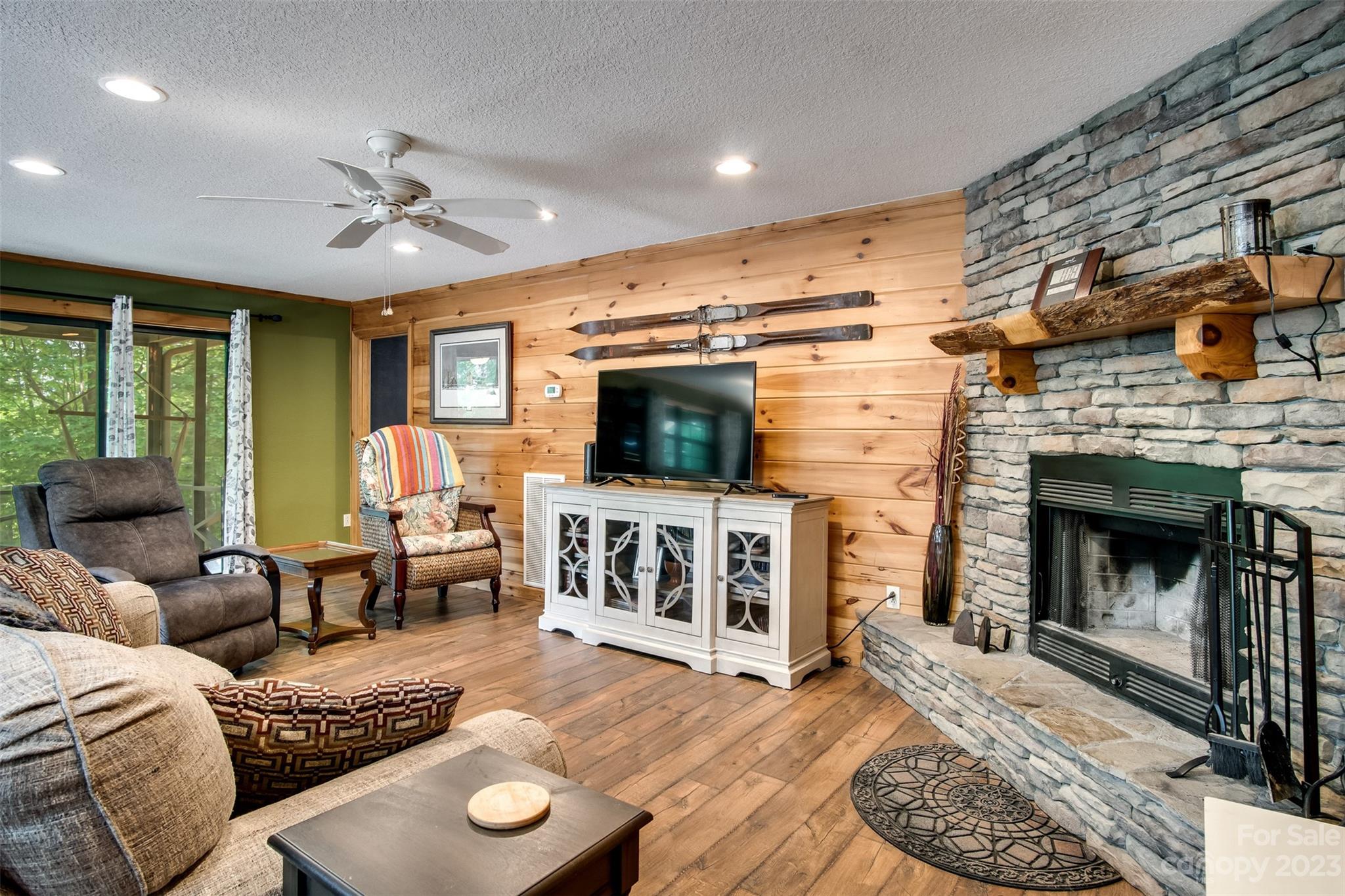 669 Walker Point Road Hayesville, NC 28904 - Photo 9 of 46 a living room with furniture a flat screen tv and a fireplace