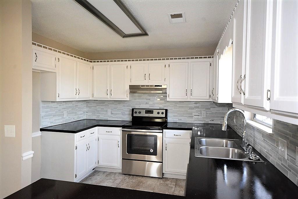 3408 Country Way Road Antioch, TN 37013 - Photo 22 of 30 a kitchen with stainless steel appliances granite countertop a stove a sink and white cabinets