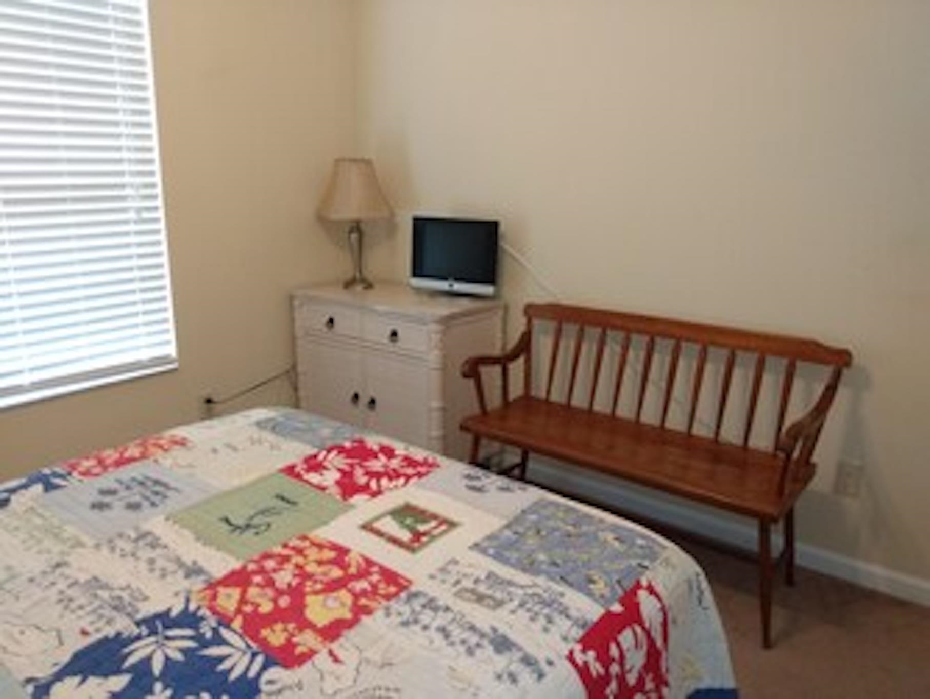 126 13th Street St. Augustine, FL 32080 - Photo 12 of 17 a bedroom with a bed and a chair