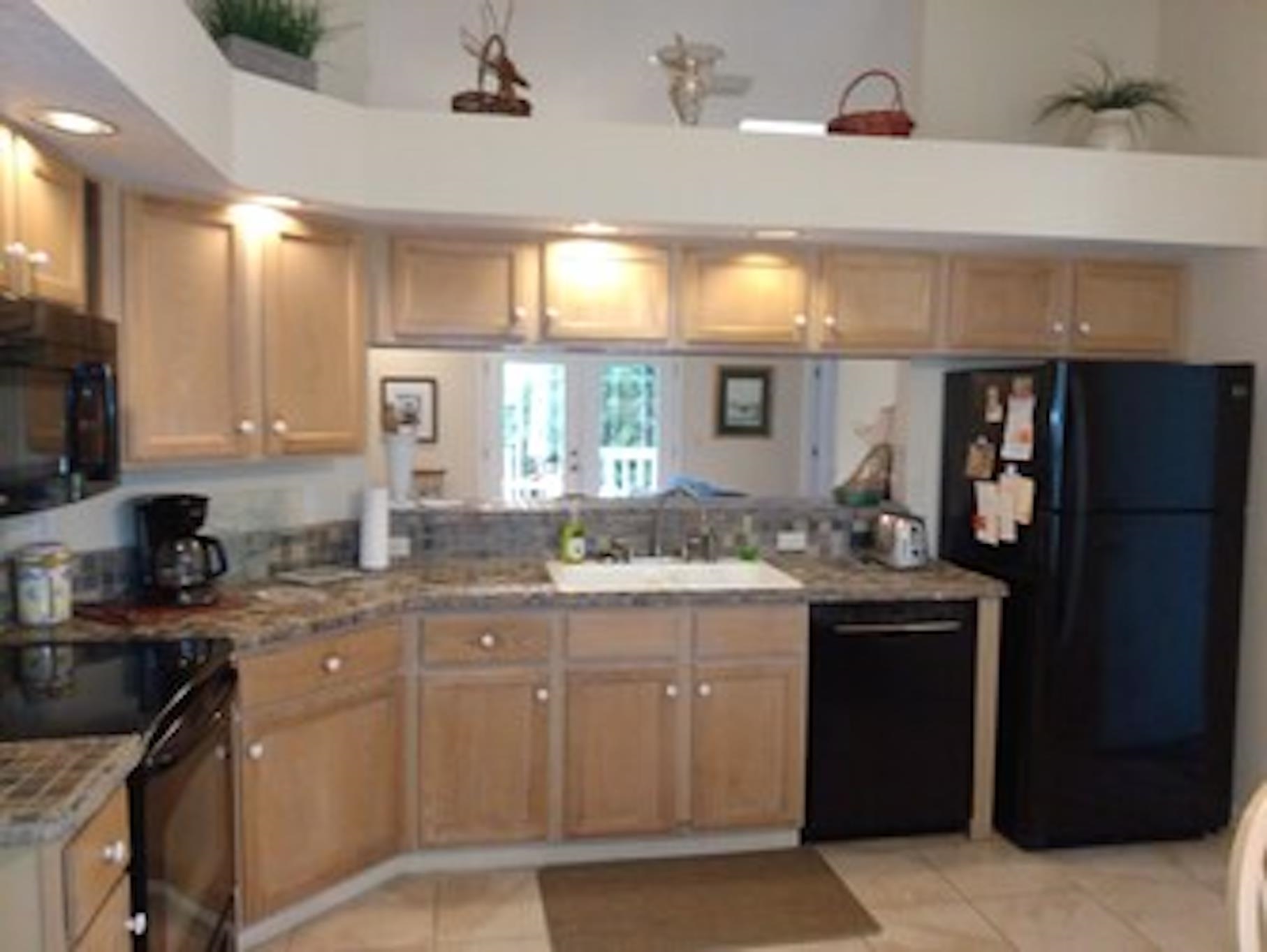 126 13th Street St. Augustine, FL 32080 - Photo 6 of 17 a kitchen with a sink stove and cabinets