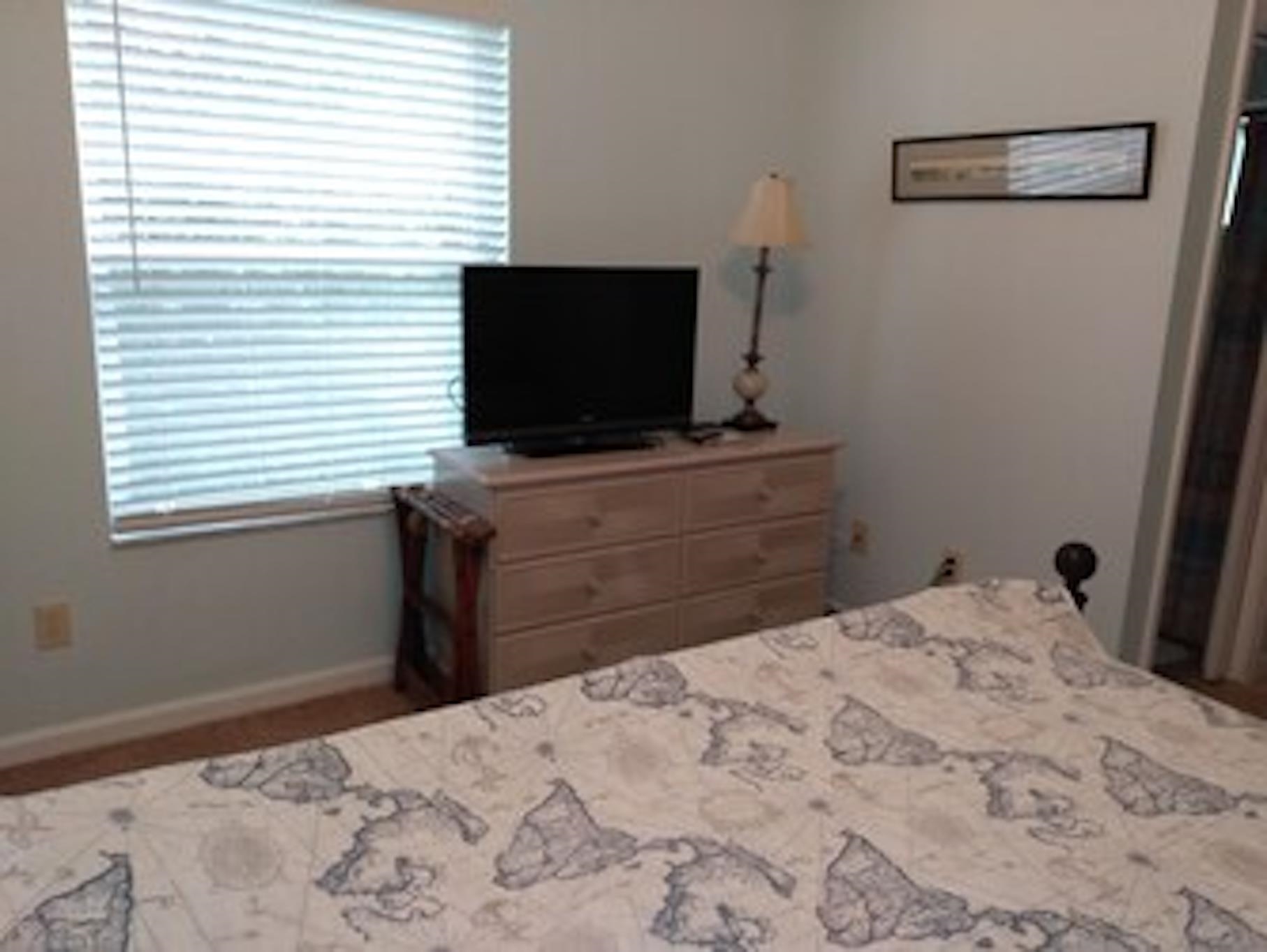 126 13th Street St. Augustine, FL 32080 - Photo 10 of 17 a bedroom with a bed and a flat screen tv
