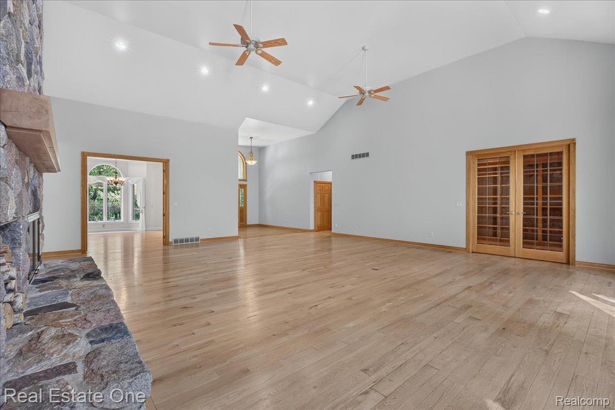 425 Courtney Road Leonard, MI 48367 - Photo 14 of 89 Spacious interior featuring soaring vaulted ceilings, recessed lighting, and wood-finish flooring