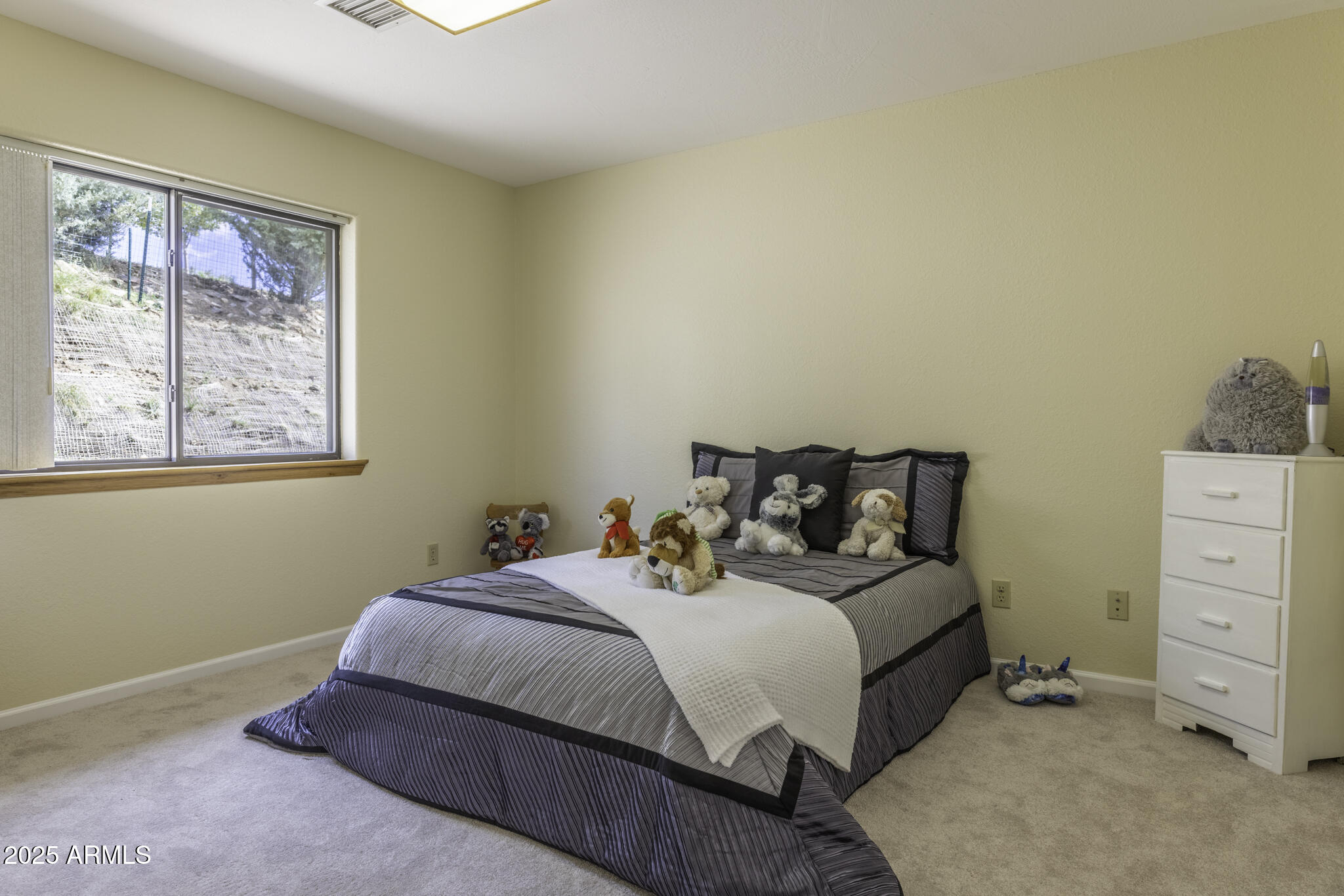 18168 Spoon Road Peeples Valley, AZ 86332 - Photo 12 of 32 a bedroom with a bed and a window