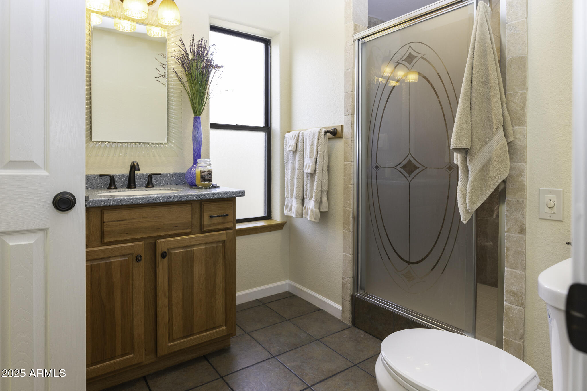 18168 Spoon Road Peeples Valley, AZ 86332 - Photo 17 of 32 a bathroom with a sink a toilet and a mirror
