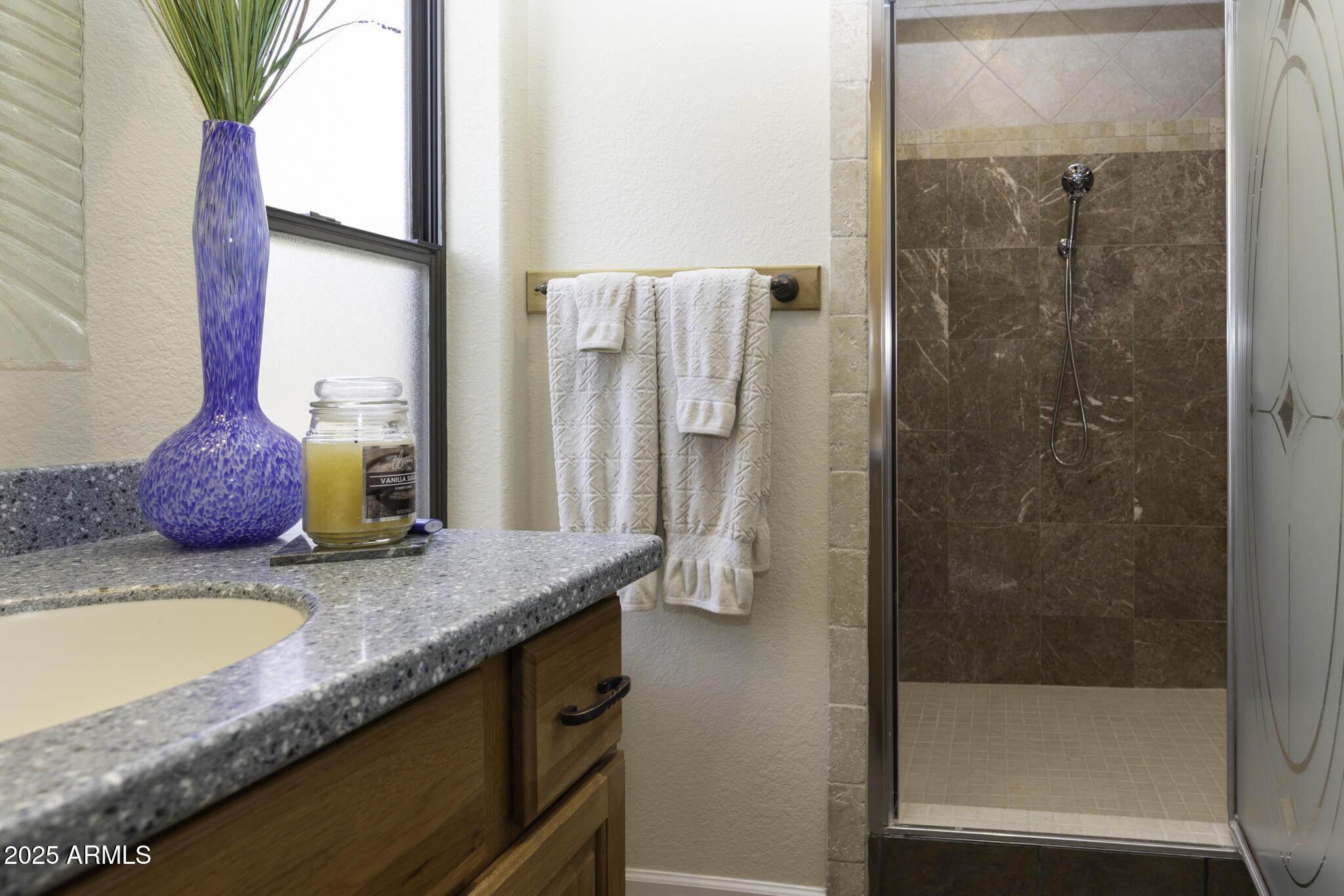 18168 Spoon Road Peeples Valley, AZ 86332 - Photo 18 of 32 a bathroom with a granite countertop sink a mirror and a shower