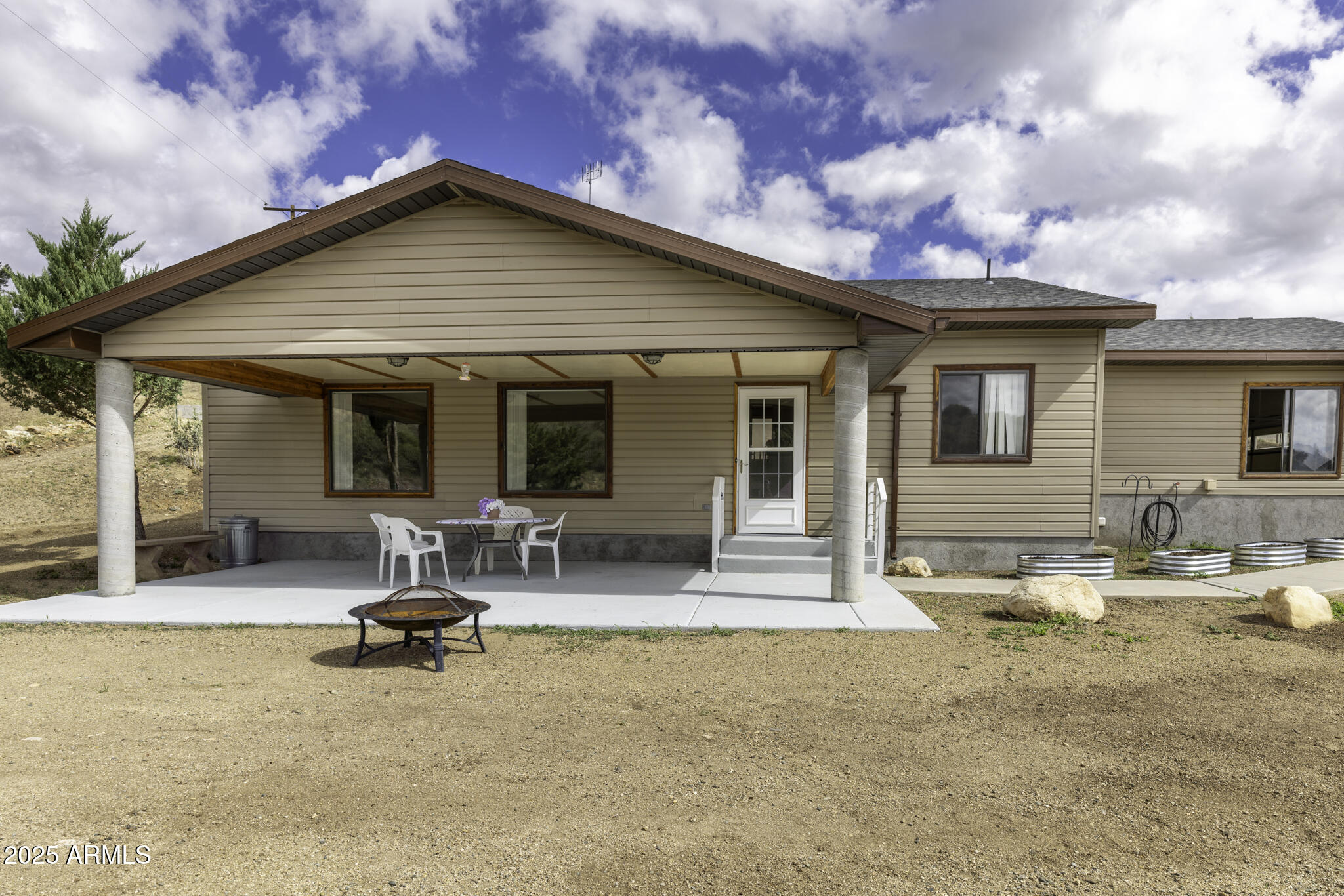 18168 Spoon Road Peeples Valley, AZ 86332 - Photo 2 of 32 a view of a house with outdoor seating area