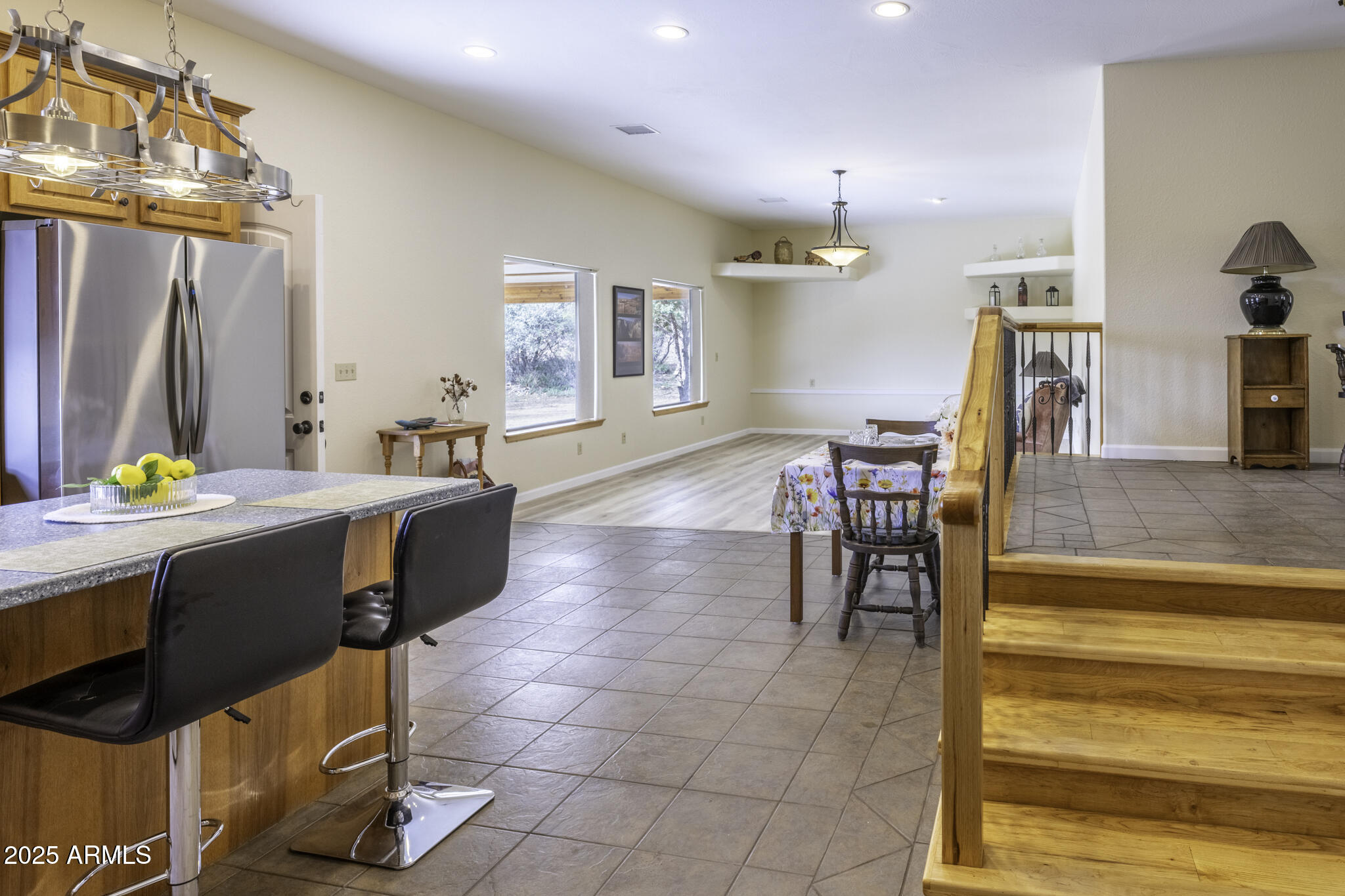 18168 Spoon Road Peeples Valley, AZ 86332 - Photo 21 of 32 a living room with couches a dining table and chairs with wooden floor