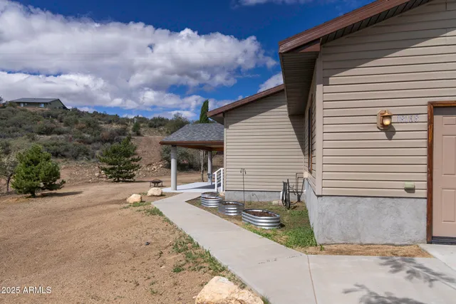 an aerial view of a house with a yard and ocean view