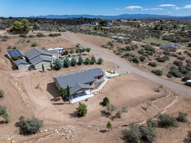an aerial view of a house with a yard
