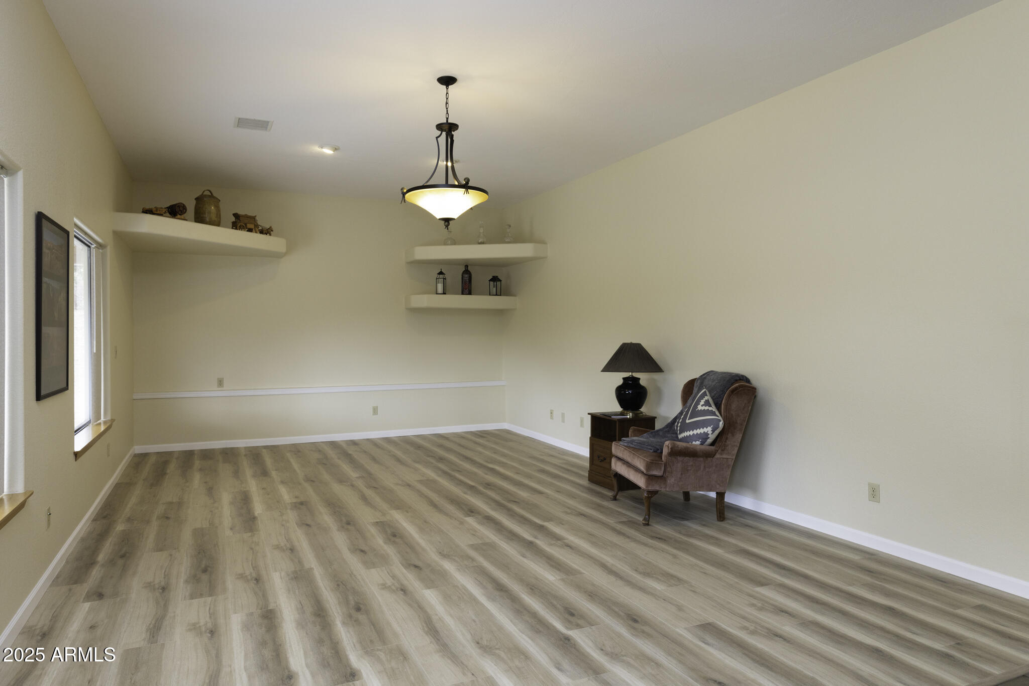 18168 Spoon Road Peeples Valley, AZ 86332 - Photo 4 of 32 a view of a room with wooden floor table and chairs