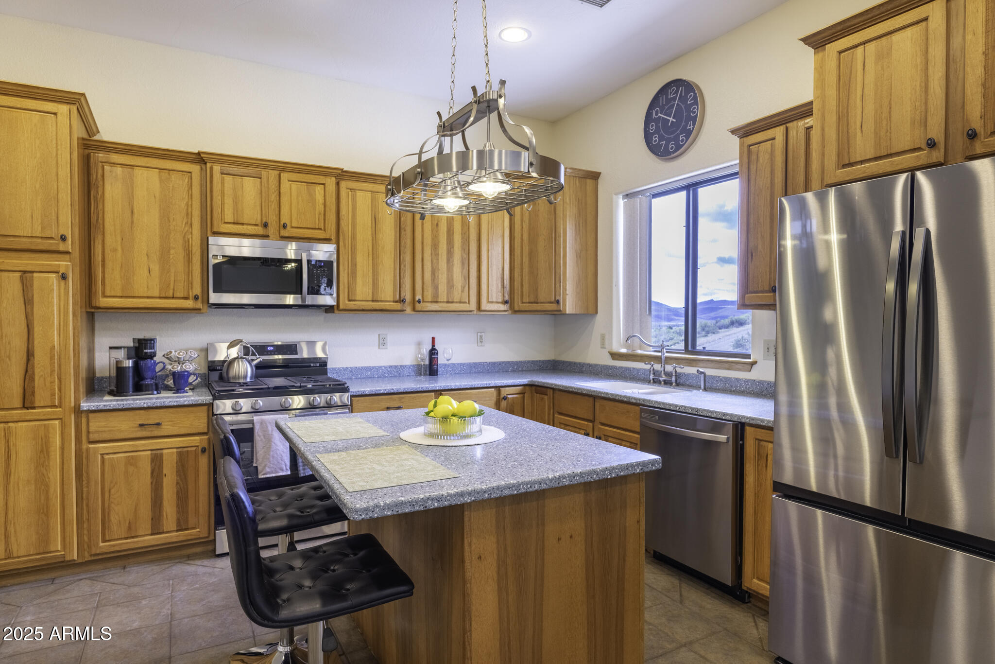 18168 Spoon Road Peeples Valley, AZ 86332 - Photo 6 of 32 a kitchen with stainless steel appliances granite countertop a refrigerator a sink dishwasher a stove and a refrigerator with wooden floor