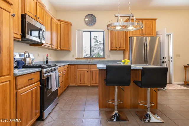 a kitchen with stainless steel appliances granite countertop a sink counter space cabinets and a window