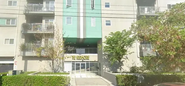 a front view of a building with a yard