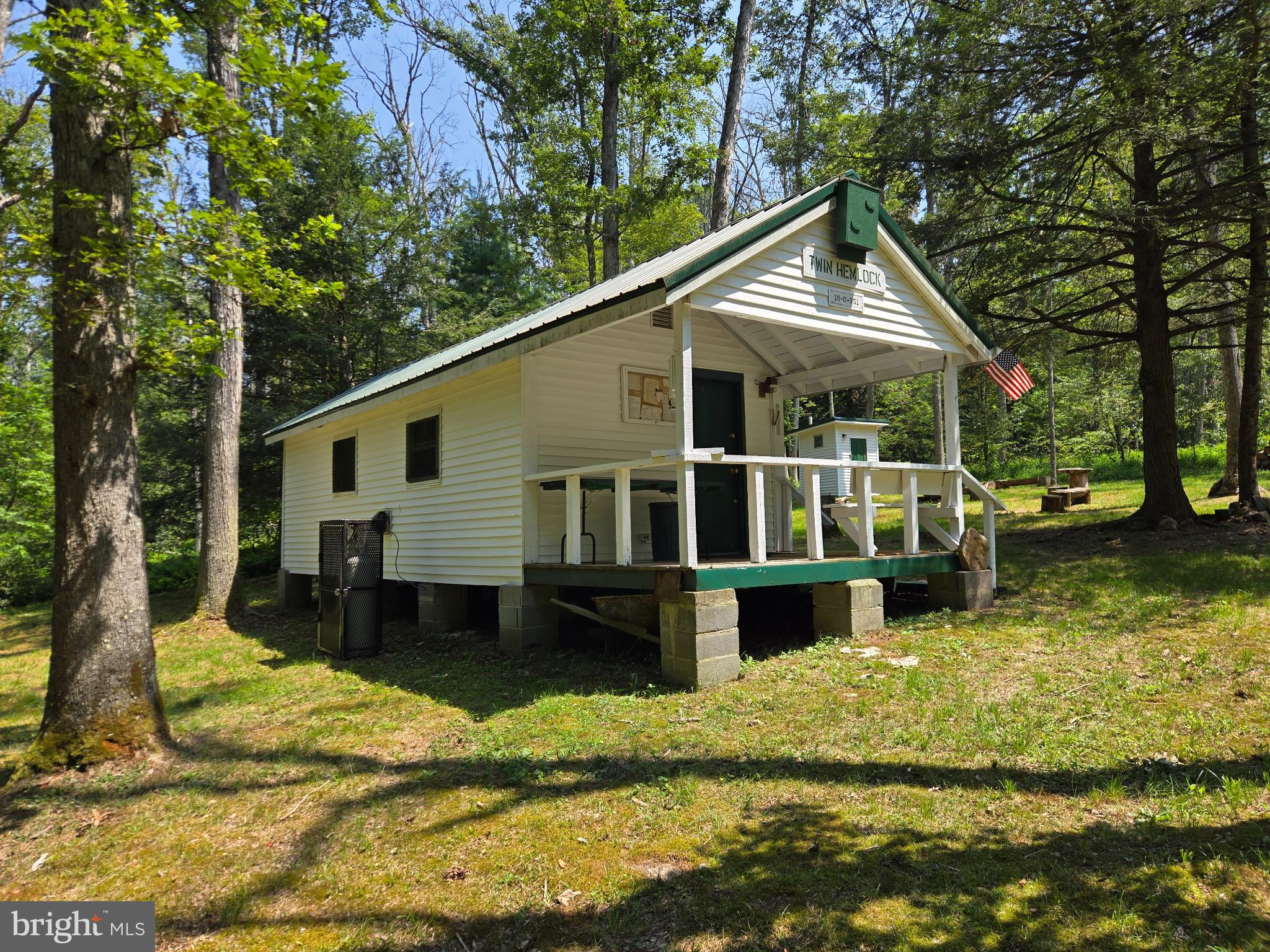 a view of a house with a yard chairs and floor to ceiling window