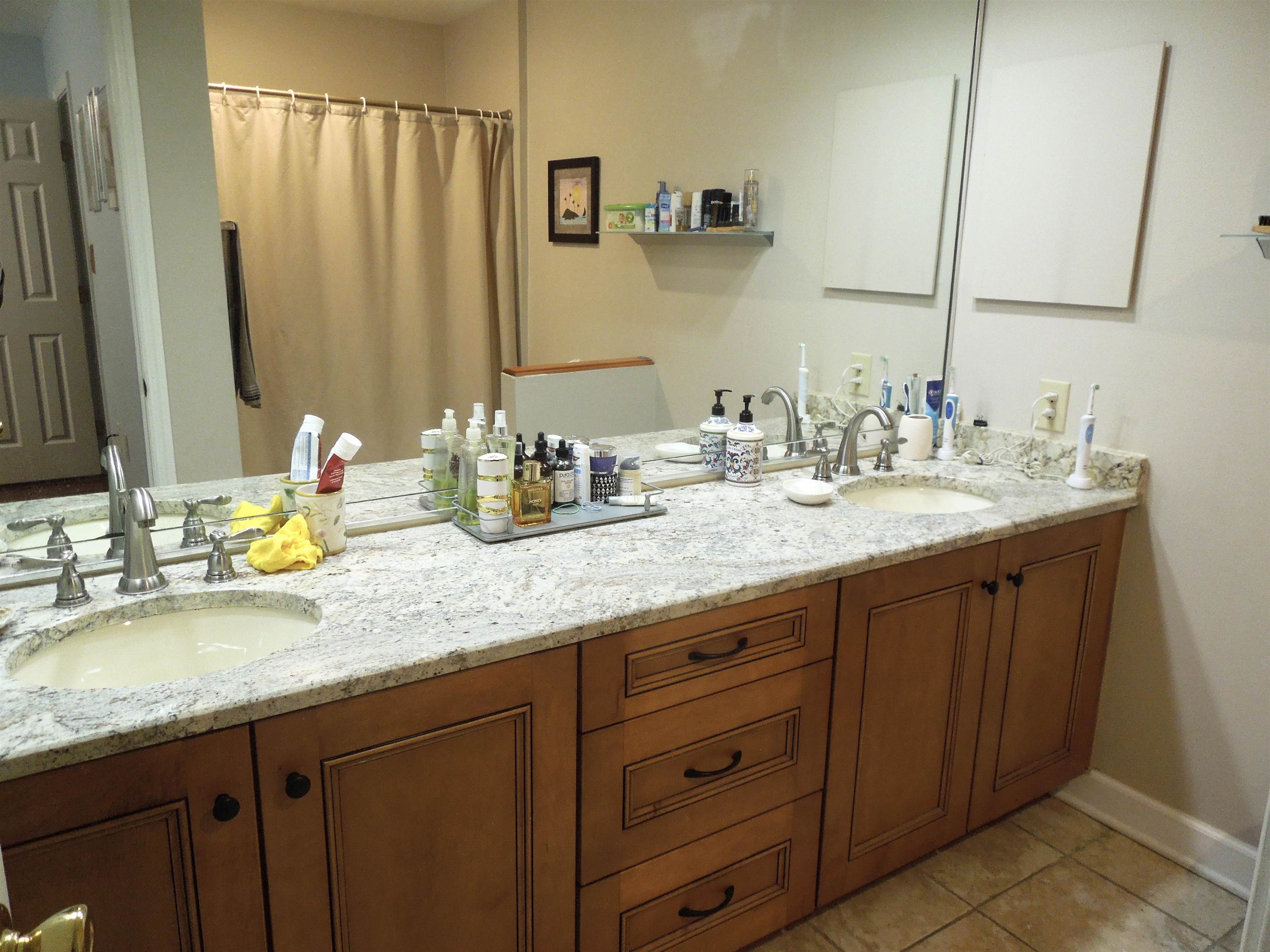 815 Willow Trace Myrtle Beach, SC 29572 - Photo 13 of 20 Bathroom featuring double vanity, curtained shower, and light tile patterned flooring