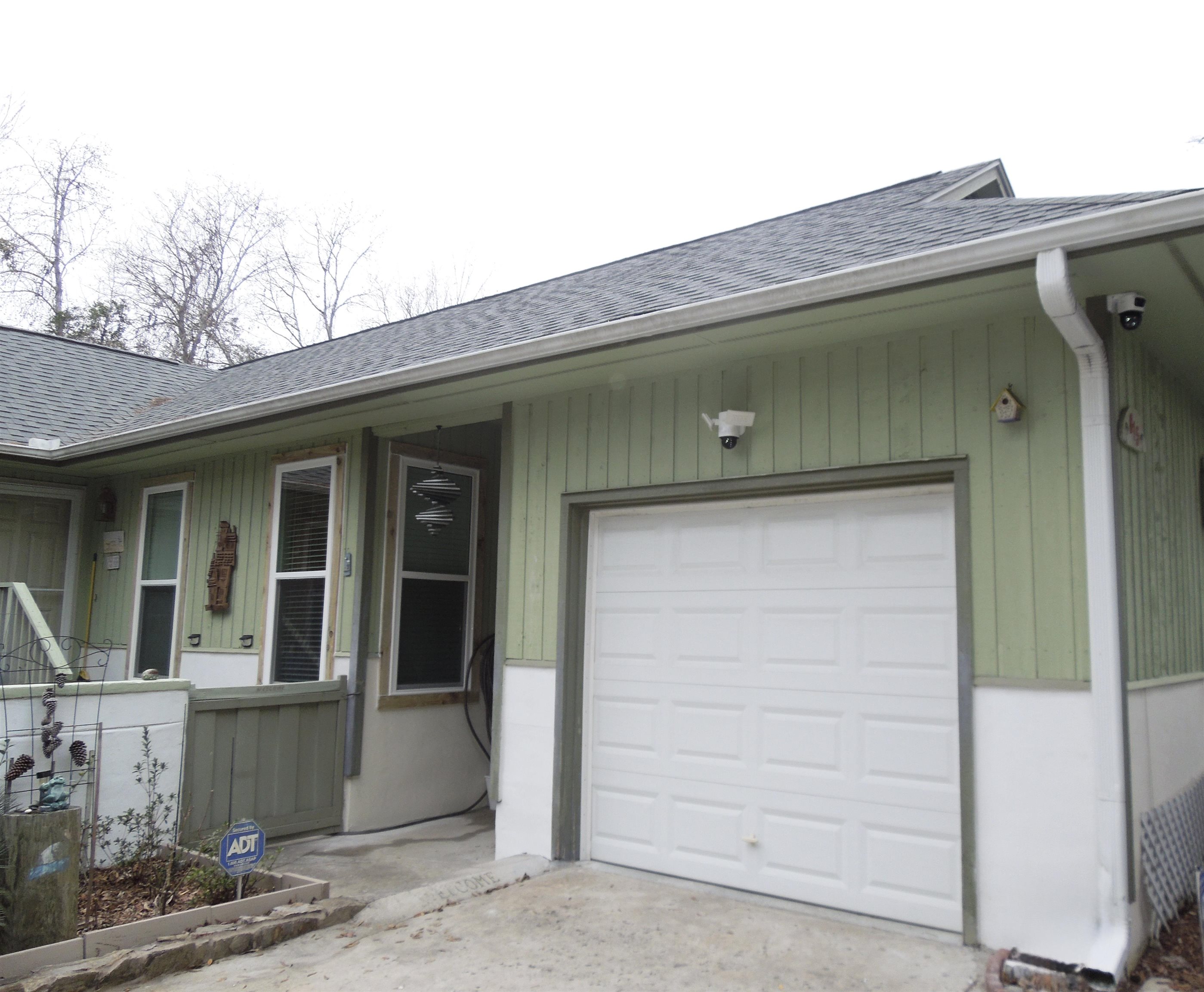 815 Willow Trace Myrtle Beach, SC 29572 - Photo 20 of 20 View of exterior entry featuring a shingled roof and an attached garage