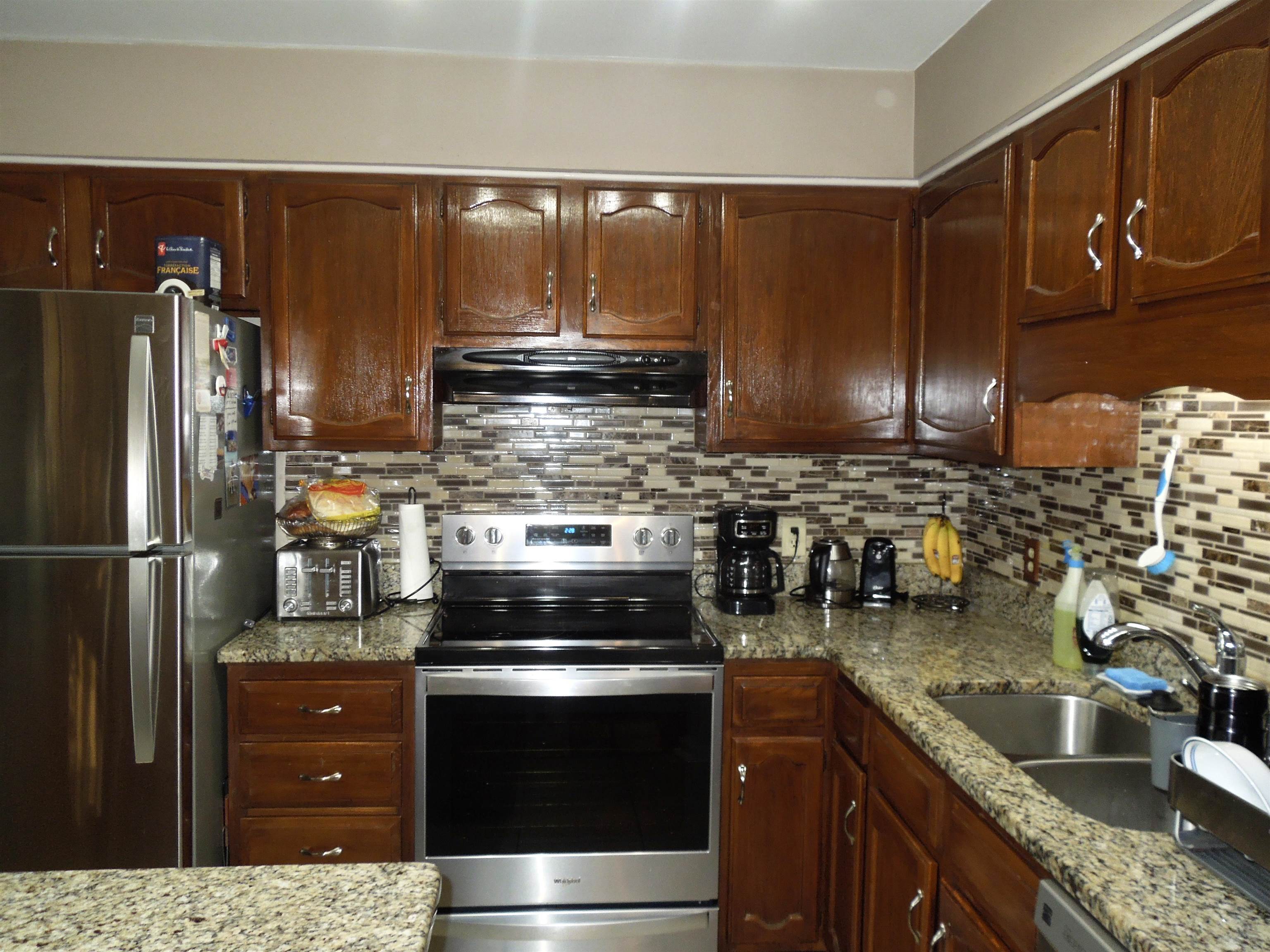 815 Willow Trace Myrtle Beach, SC 29572 - Photo 9 of 20 Kitchen featuring stainless steel appliances, light stone counters, backsplash, and extractor fan