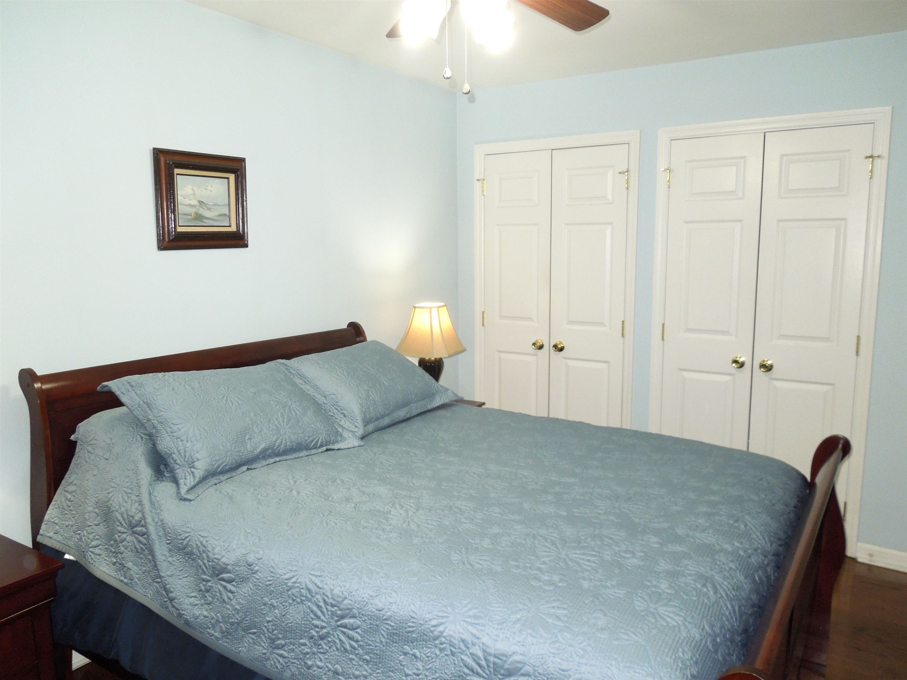 815 Willow Trace Myrtle Beach, SC 29572 - Photo 10 of 20 Bedroom featuring two closets, a ceiling fan, and wood finished floors