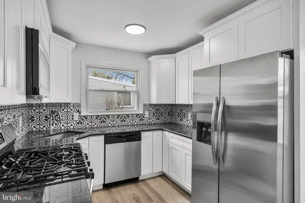 a kitchen with a sink stove and refrigerator
