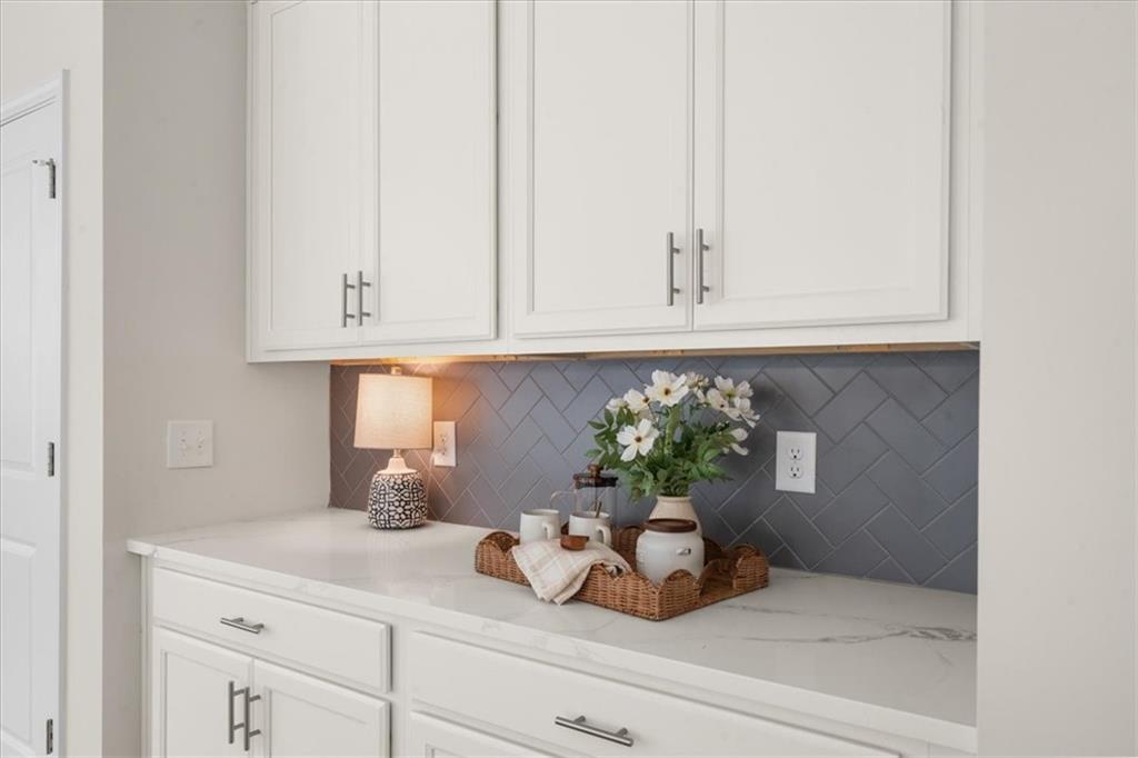 8620 Standing Stone Ball Ground, GA 30107 - Photo 28 of 61 a kitchen with a potted plant on the counter and cabinets