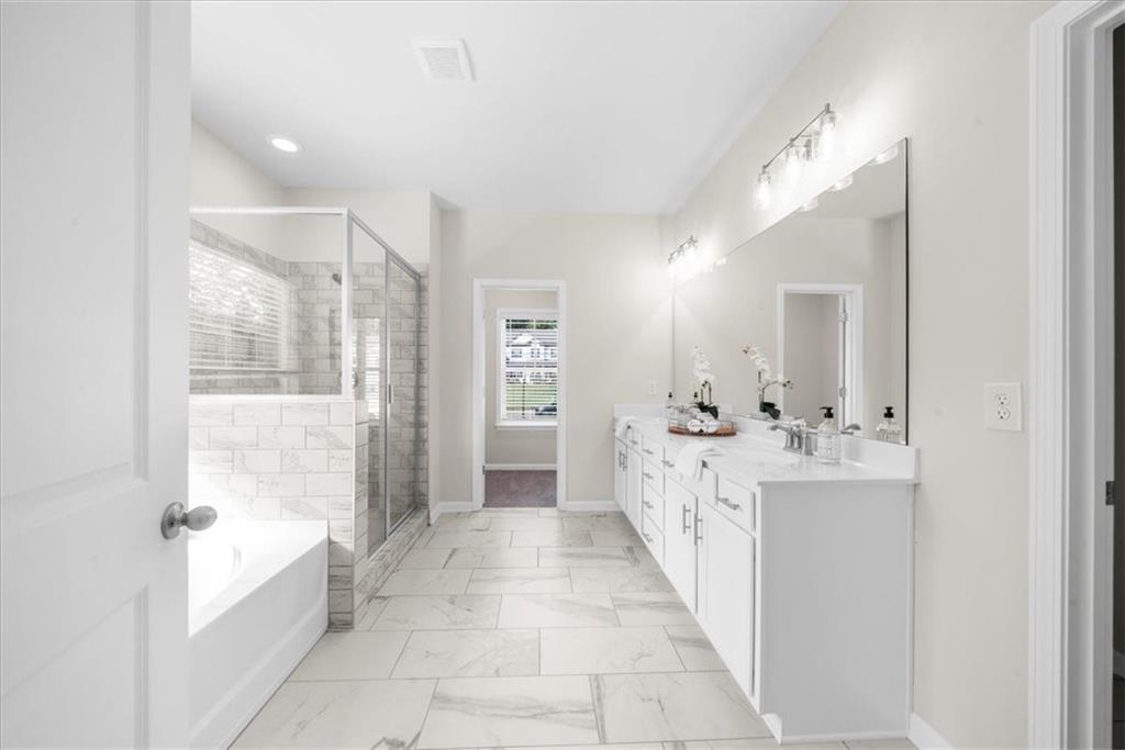 8620 Standing Stone Ball Ground, GA 30107 - Photo 37 of 61 a large white bathroom with a tub sink and mirror