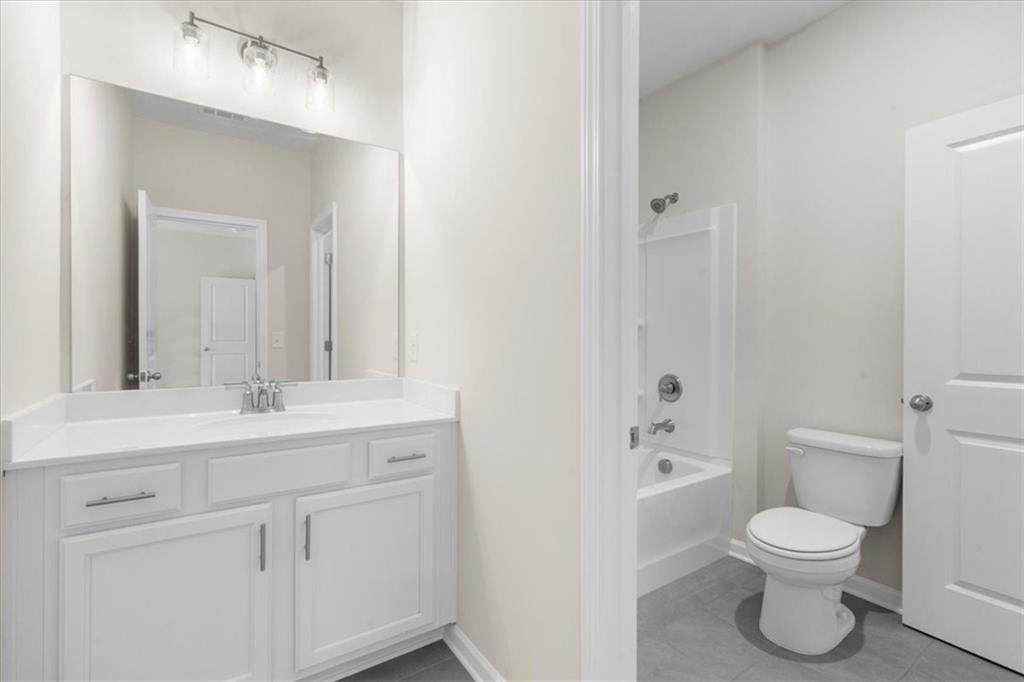 8620 Standing Stone Ball Ground, GA 30107 - Photo 46 of 61 a bathroom with a toilet sink and mirror