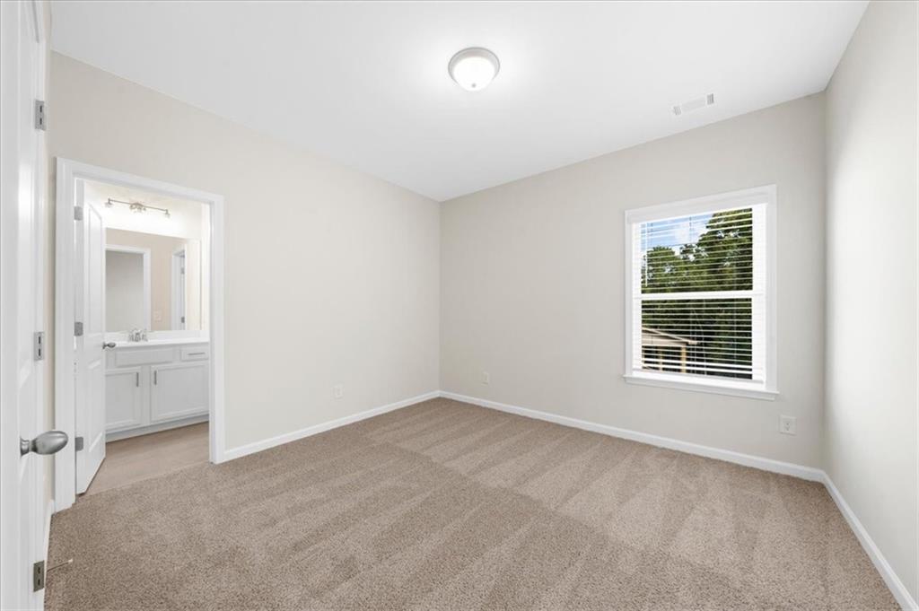 8620 Standing Stone Ball Ground, GA 30107 - Photo 48 of 61 a view of an empty room with a window and a kitchen
