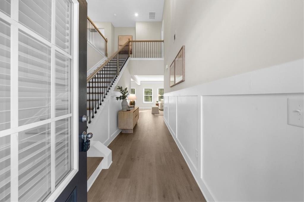 8620 Standing Stone Ball Ground, GA 30107 - Photo 7 of 61 a view of a hallway with wooden floor and staircase