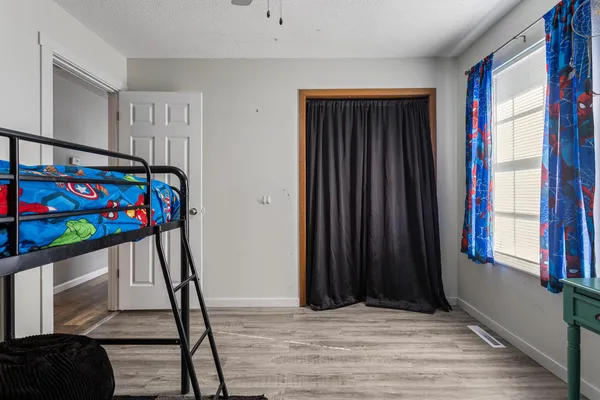 a bedroom with a bed and a window