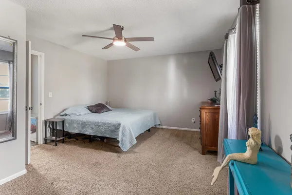 a bedroom with a bed and flat screen tv
