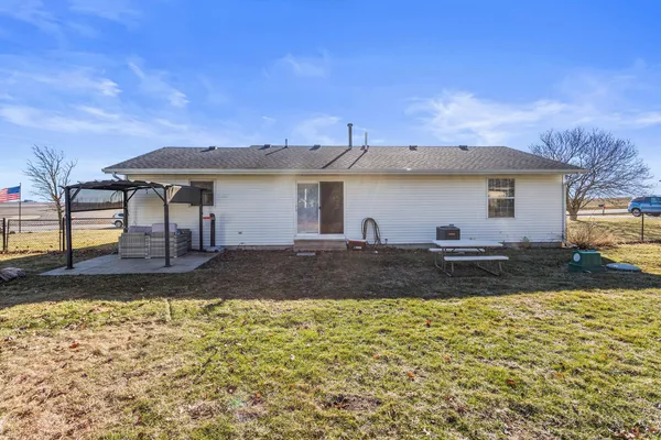 a view of a house with couches chairs and wooden floor