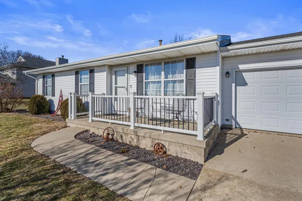 a view of a house with a wooden deck