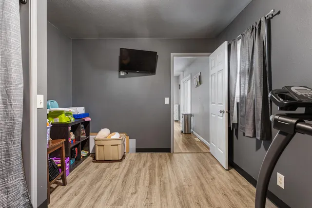 a bedroom with a bed and a tv on the dresser