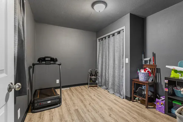 a bedroom with a bed and a tv on the dresser