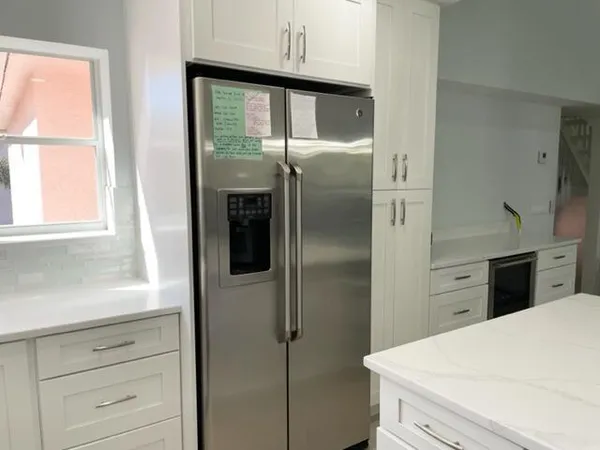 a kitchen with a refrigerator and a window