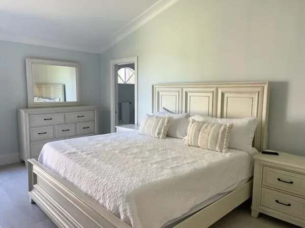 a bedroom with a bed and a dresser