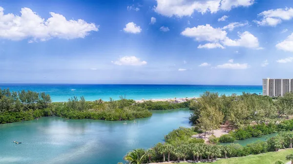 an aerial view of residential houses with outdoor space and lake view